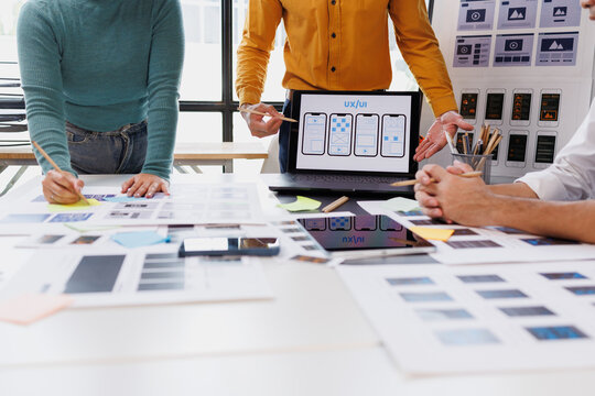 Ux ui designers collaborating on app interface wireframes and mobile web development prototyping process