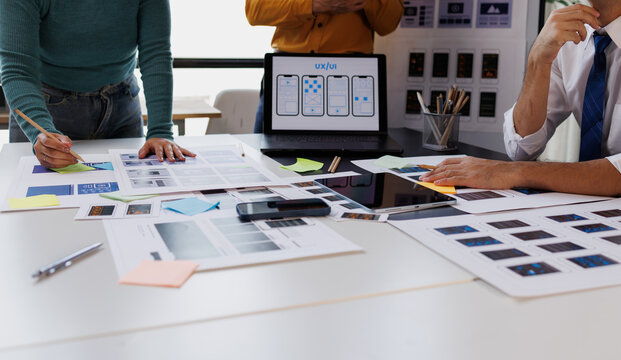 Ux ui designers brainstorming and collaborating on mobile application development workflow, creating user interfaces