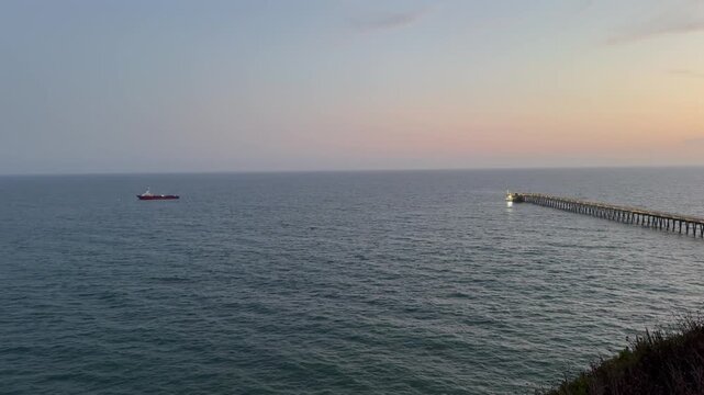 Beautiful panoramic aerial view of the Goleta Pier and a moored ship at sunset, Santa Barbara County, Southern California