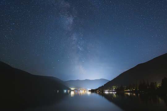 Milky Way Galaxy visible over the calm and still West Arm of Kootenay Lake and Nelson BC, Canada on a summer night.