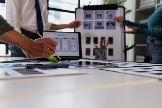 Design team hands actively working on ui ux design, planning and prototyping responsive web and mobile application development