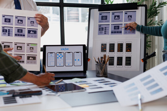 Ui ux designers collaborating on web and app wireframes, planning digital user experience interface