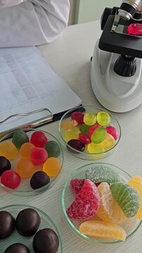 Candy analysis at the lab with microscope and samples in clear dishes