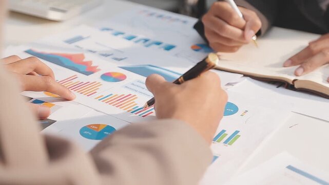 Business partnership coworkers using a tablet to analysis graph company financial budget report and cost work progress and planning for future in office room.