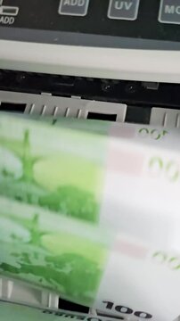 Money being processed by a machine in a cash handling location