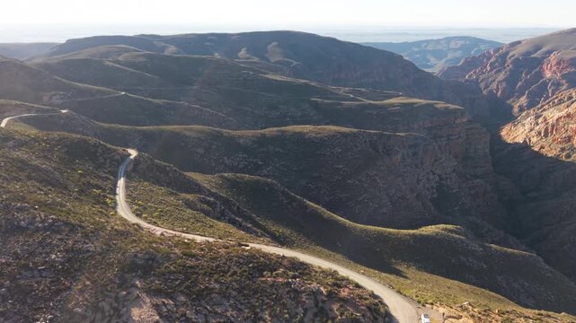 Aerial of winding dirt road mountain pass, Swartberg pass, South Africa
