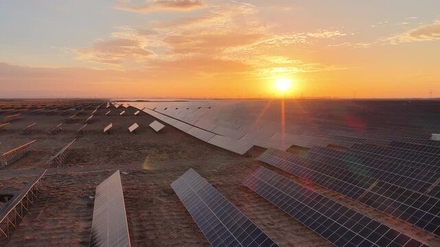 Stunning Sunset over Vast Solar Panel Farm in Remote Sandy Desert Landscape