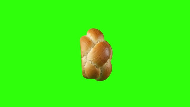 Freshly baked golden-brown braided challah bread loaf floating and spinning against a solid green screen keying backdrop. Excellent for bakery commercials, Jewish holiday promos, traditional baking vi