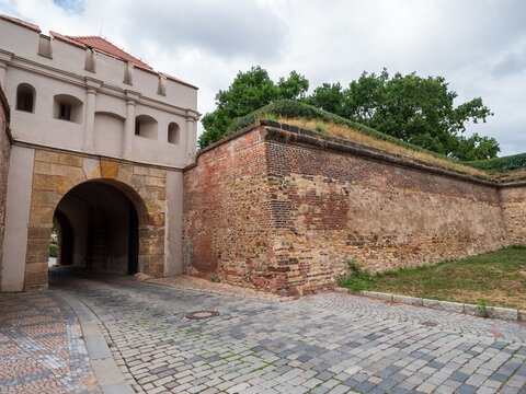 Historic Tabor Gate and brick fortification walls at Vysehrad fortress in Prague, Czech Republic. Baroque entrance to the famous cultural landmark and historic defensive complex.