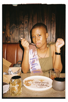 Young woman enjoying a sweet birthday treat