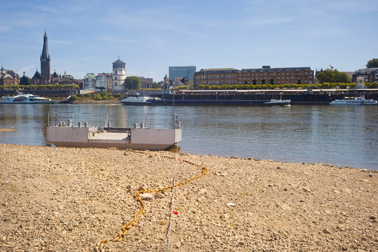 D&uuml;sseldorf, Germany,low stream gauge of rhine river.Water shortage, drought, climate change,global warming concept, due to the drought, ships can only operate with reduced cargo.