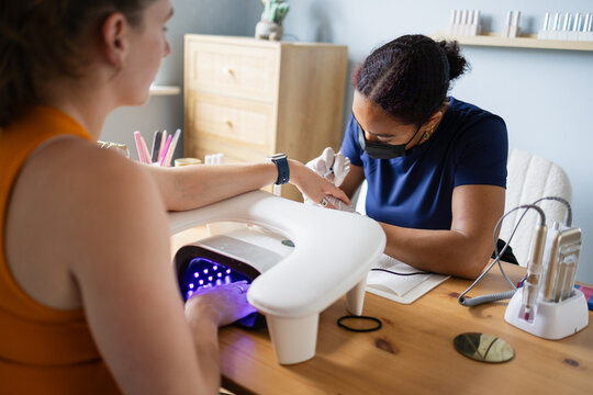 Nail technician giving a professional manicure