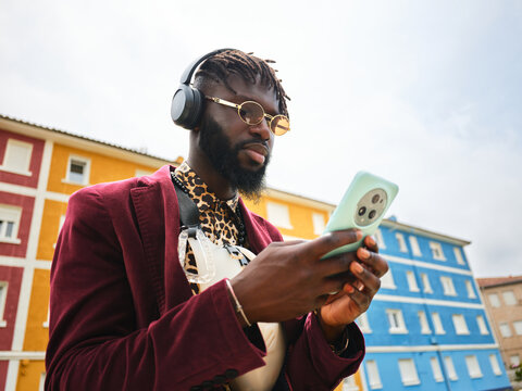 Afro american man using smartphone in urban street