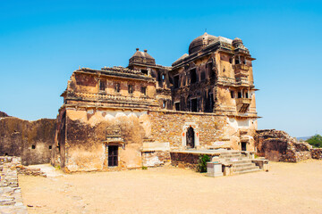 Fototapeta premium Old broken palace structures and stone ruins within the historic Chittorgarh Fort complex