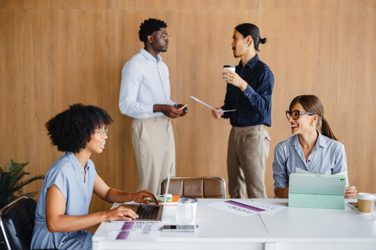 Team Collaborates in Office Over Coffee