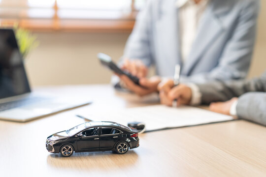 Business transport car and sell service concept, sales calculate sell price or rent of car for customer before sign on vehicle paperwork document contract with buyer woman client transfer automobile.