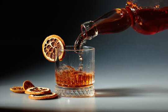 Whiskey is poured into a in crystal glass.