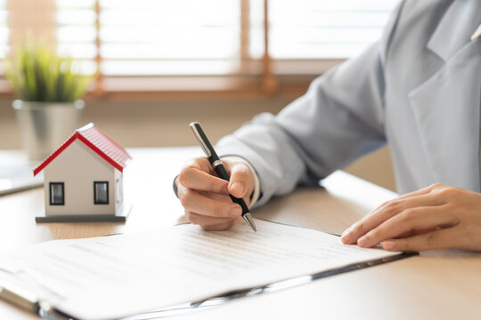 Property lease concept, asian woman tenant, client rental purchase, buyer apartment or home with landlord  hand document signing contract, holding pen putting signs signature paper on desk office.