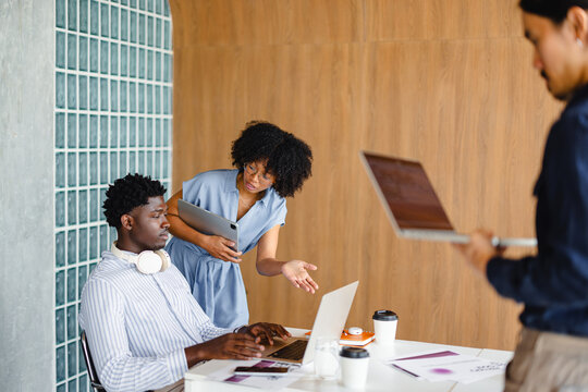 Group Works on Projects in Modern Office Space During the Day