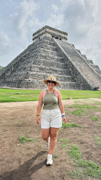 Woman traveling and exploring ancient Chichen Itza pyramid in Mexico
