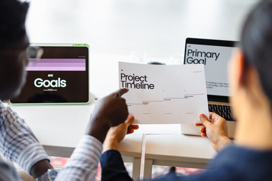 Team Discusses Project Timeline and Goals at Meeting Table