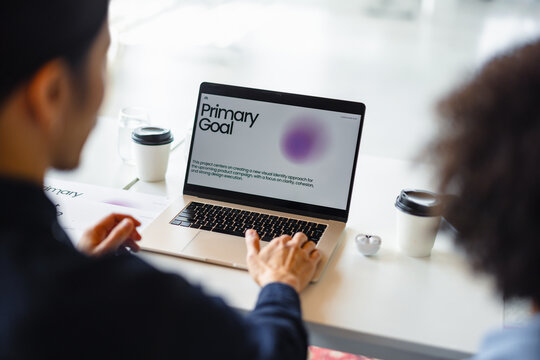 Working on a Laptop With a Focus on Primary Goal in a Modern Setting