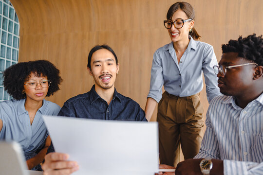 Group of People Discussing Ideas in a Modern Office Space