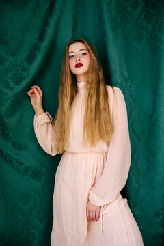 Woman in dress against green backdrop