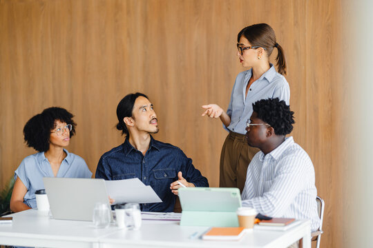 Meeting in a Conference Room With Team Members Discussing Tasks