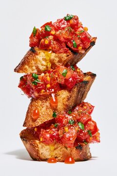Tomato Bruschetta Balanced Tower on White Background