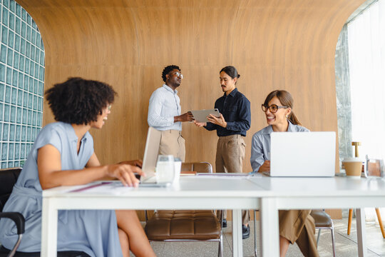 Team Members Discuss Ideas in Modern Office Space