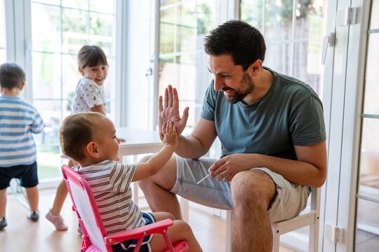 Father High-Fiving Happy Toddler