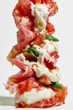 Prosciutto and Burrata Sculptural Column on White Background