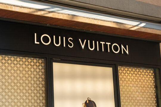Bari, Italy - July 31, 2026: Louis Vuitton logo signage above storefront windows with patterned interior visible