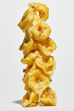 Creamy Tortellini Close Up Stack on White Background