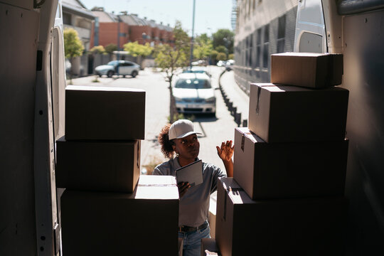 Delivery worker checking packages in a delivery van