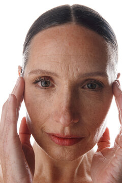 Close-up portrait of a woman touching her face