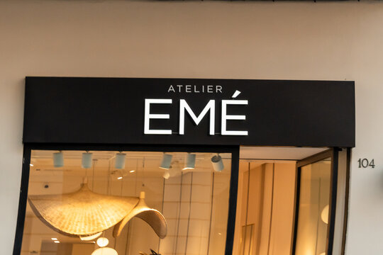 Bari, Italy - July 31, 2026: Atelier Eme storefront signage above a fashion boutique entrance with interior lighting