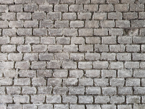 White brick wall texture background. Old whitewashed brickwork pattern with rough mortar joints.