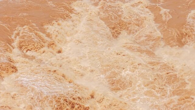 Telephoto pull back shot of powerful canyon waterfall rapids flowing between rugged rocks. Cinematic natural force footage for environmental storytelling, documentaries, and nature videos.