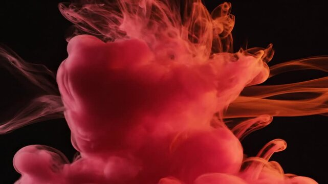 Abstract red ink cloud in water exploding and spreading against a black background with ethereal movement