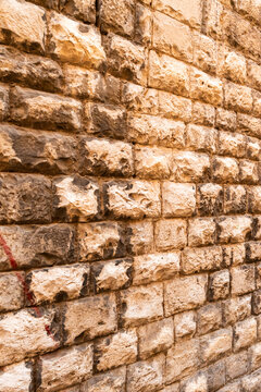 Weathered brick wall texture with warm reddish tones and natural aging pattern
