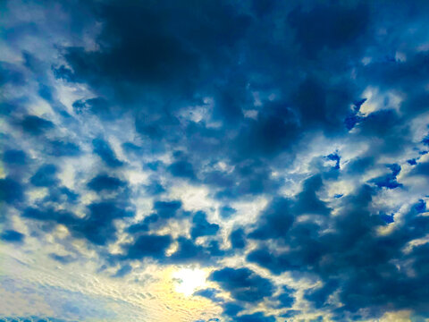 Dramatic sky with dark storm clouds and bright sunlight breaking through, creating a beautiful contrast in the atmosphere