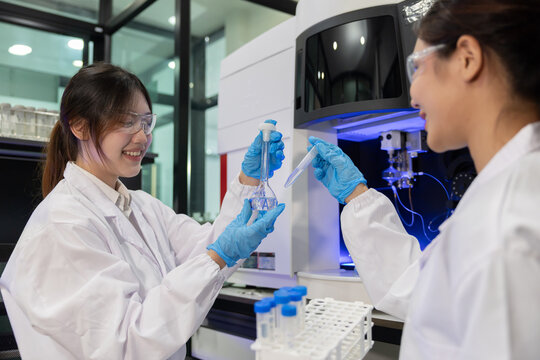 Laboratory technician conducts experiments with test tubes in a modern research facility