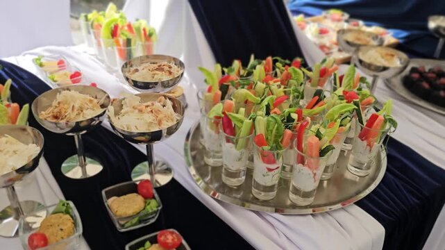 Bright and colorful food display at a gathering with refreshments and appetizers served on tables