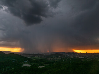 Fototapeta premium dark storm clouds gathering over city at sunset