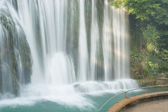 Pliva Waterfall in Jajce, Bosnia and Herzegovina surrounded by lush green forest