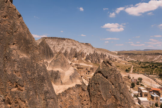 Panoramic view of volcanic cone rocks and ancient cave formations in Selime Cappadocia Turkey offering tranquil escape into nature.