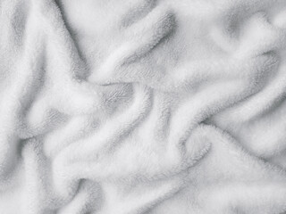 Soft fluffy white fleece blanket texture with folds and plush furry surface © Алена Ченкова