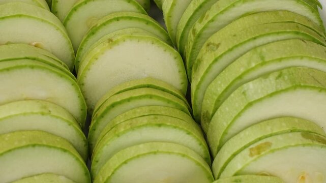 Green zucchini. Sliced raw zucchini close up, rotate